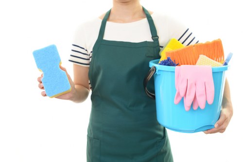 Tenant cleaning a bright kitchen during end of tenancy cleaning