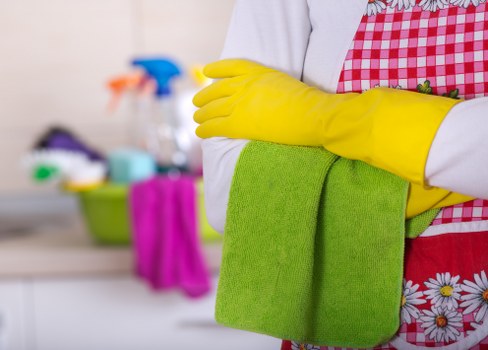 Cleaning staff sanitizing office desks and shared surfaces