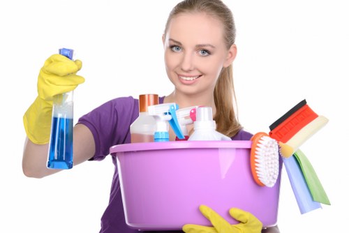 Professional cleaner maintaining staircase and lift area cleanliness